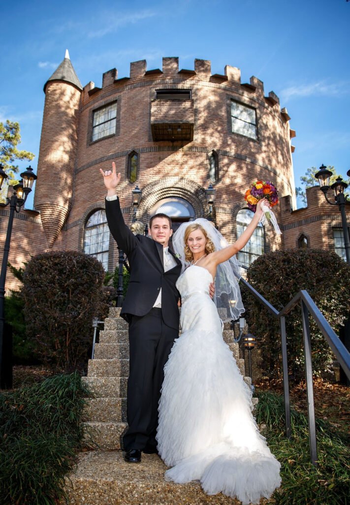 bride and groom at castle waving