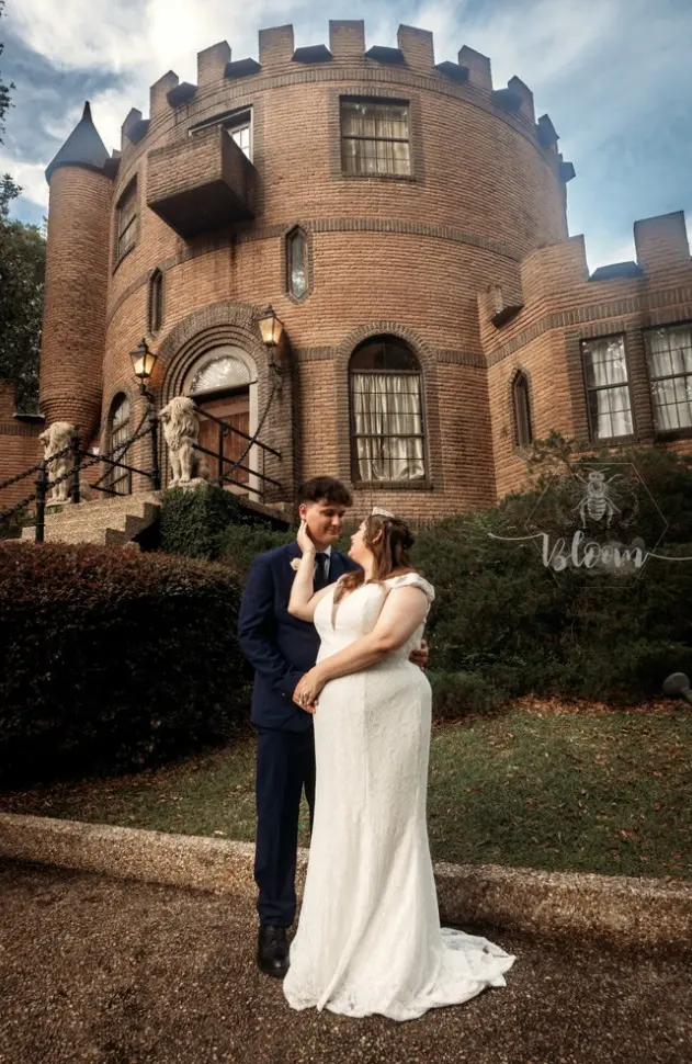 bride and groom outside a castle