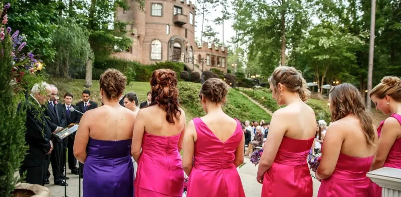 bridesmaids looking at brdie coming down stairs at a castle