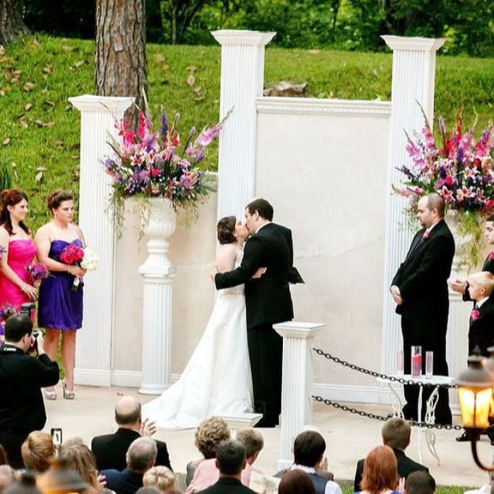 bride and groom kissing after outdoor ceremony